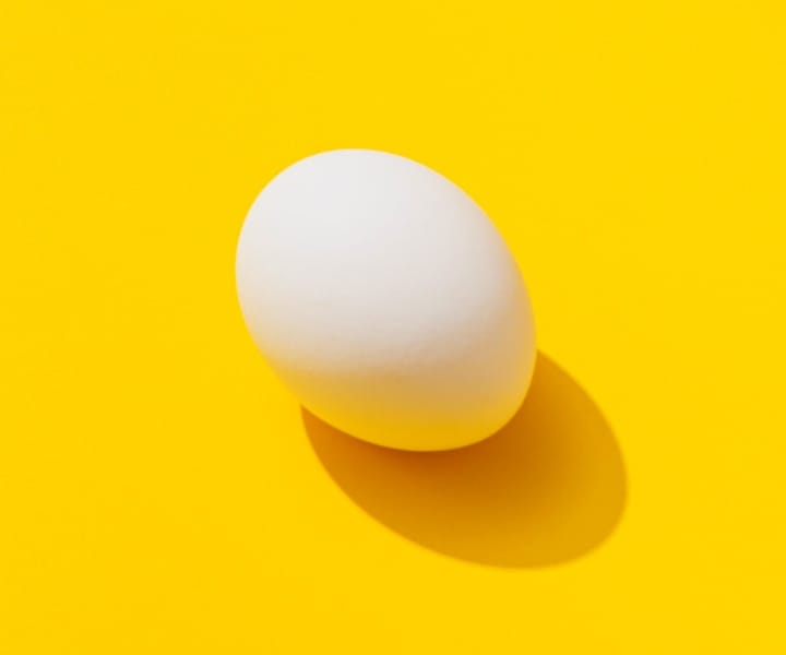 egg on yellow surface